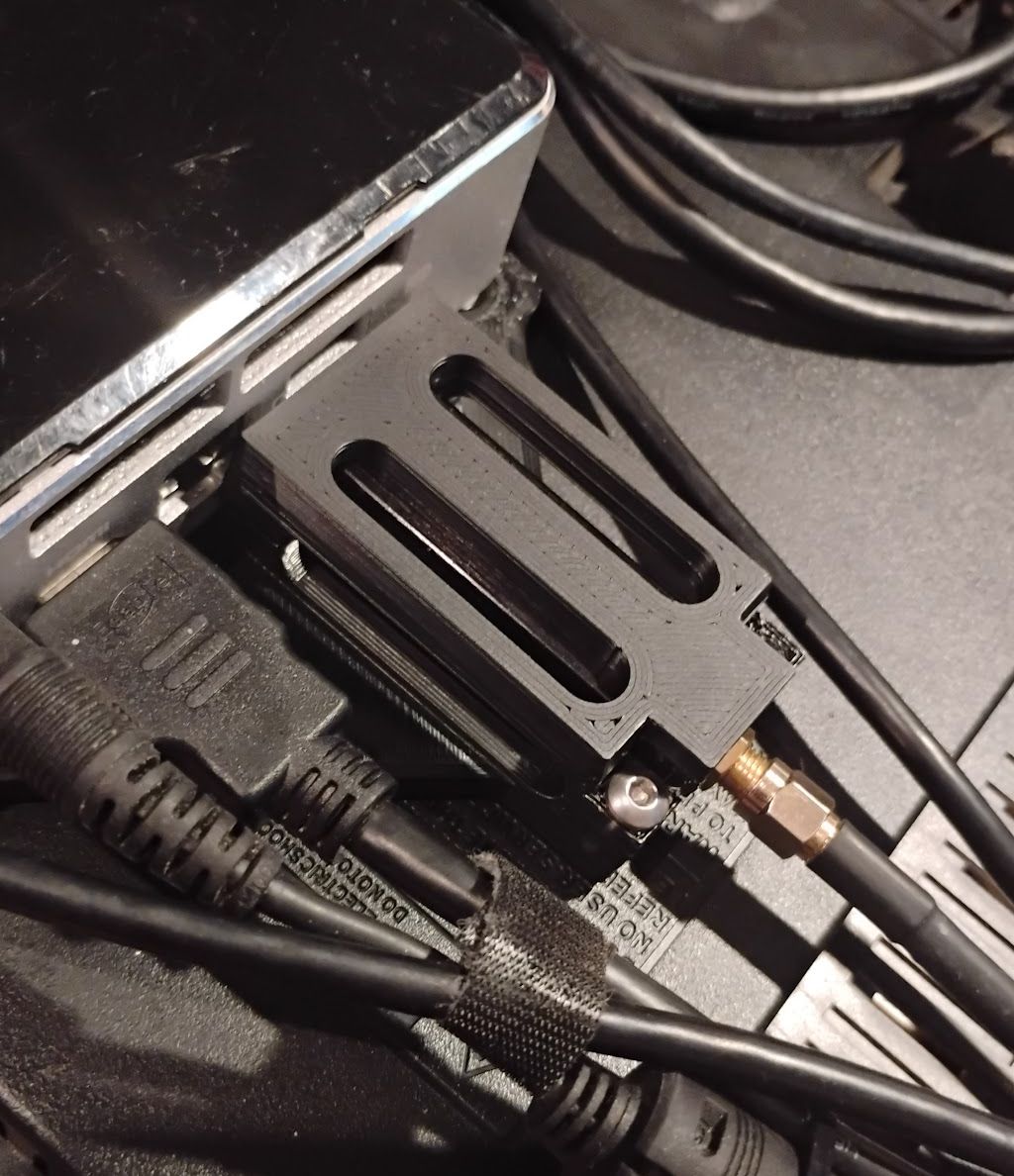 A close of up of the rear of the computer where a plastic cage secures a USB device against damage/removal.
